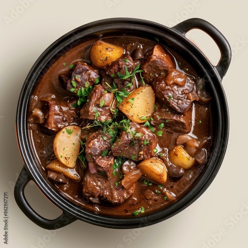 Beef Stew with Potatoes and Herbs in a Black Pot