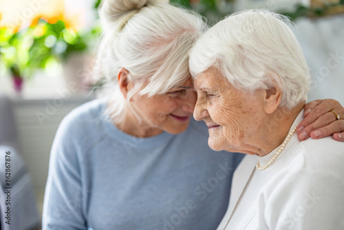 Happy senior woman with her adult daughter at home
 photo