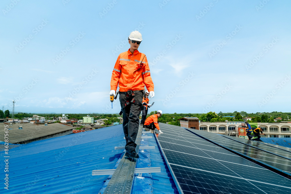 engineer man inspects construction of solar cell panel or photovoltaic cell by electronic device. Industrial Renewable energy of green power. factory worker working on tower roof. engineer man inspects construction of solar cell panel or photovoltaic cell by electronic device. Industrial Renewable energy of green power. factory worker working on tower roof.