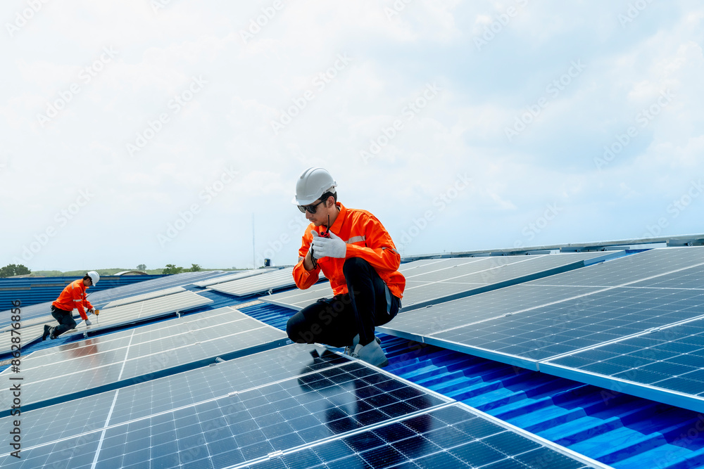 engineer man inspects construction of solar cell panel or photovoltaic cell by electronic device. Industrial Renewable energy of green power. factory worker working on tower roof. engineer man inspects construction of solar cell panel or photovoltaic cell by electronic device. Industrial Renewable energy of green power. factory worker working on tower roof.