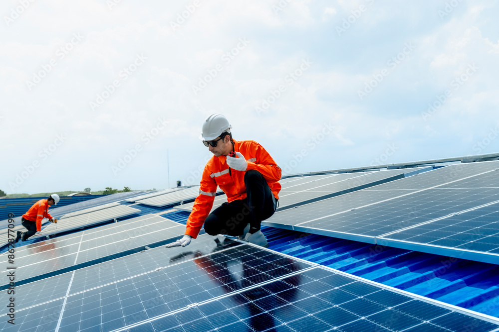 engineer man inspects construction of solar cell panel or photovoltaic cell by electronic device. Industrial Renewable energy of green power. factory worker working on tower roof. engineer man inspects construction of solar cell panel or photovoltaic cell by electronic device. Industrial Renewable energy of green power. factory worker working on tower roof.