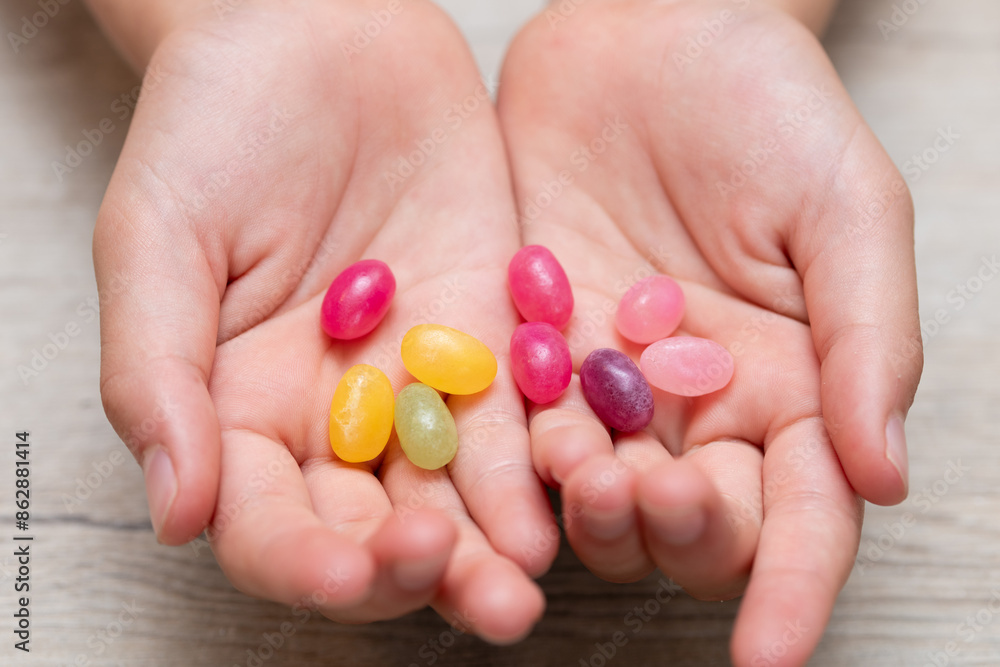 カラフルなキャンディーを持った子供の手