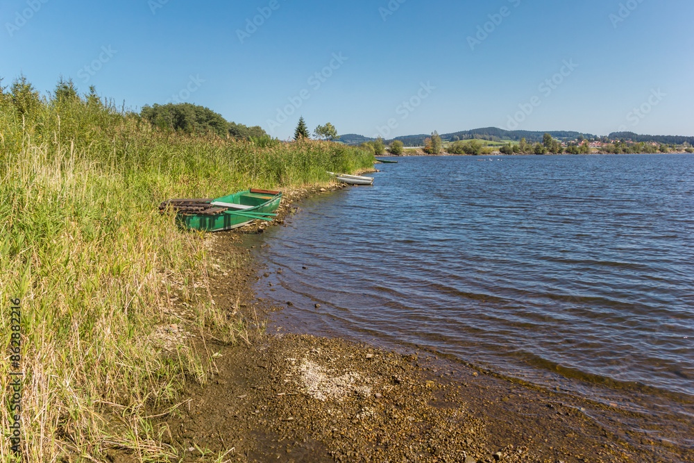 Wooden rowing boats on the shore of lake Lipno in the Sumava mountains, Czechia