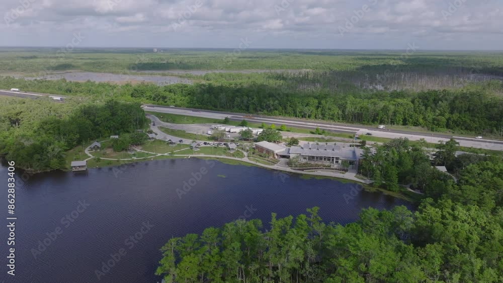 Aerial view of a peaceful Louisiana rest area near a river, with green forests and roads on a sunny day. Nature and travel concepts Aerial view of a peaceful Louisiana rest area near a river, with green forests and roads on a sunny day. Nature and travel concepts