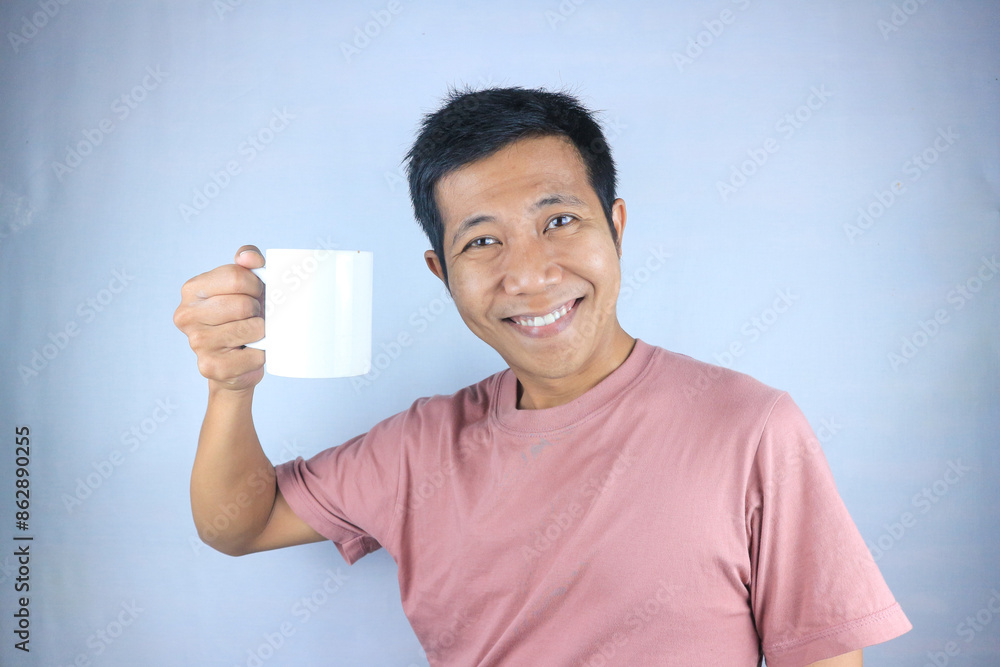Smiling expression young asian man wearing t-shirt holding coffee cup, isolated on white background Smiling expression young asian man wearing t-shirt holding coffee cup, isolated on white background
