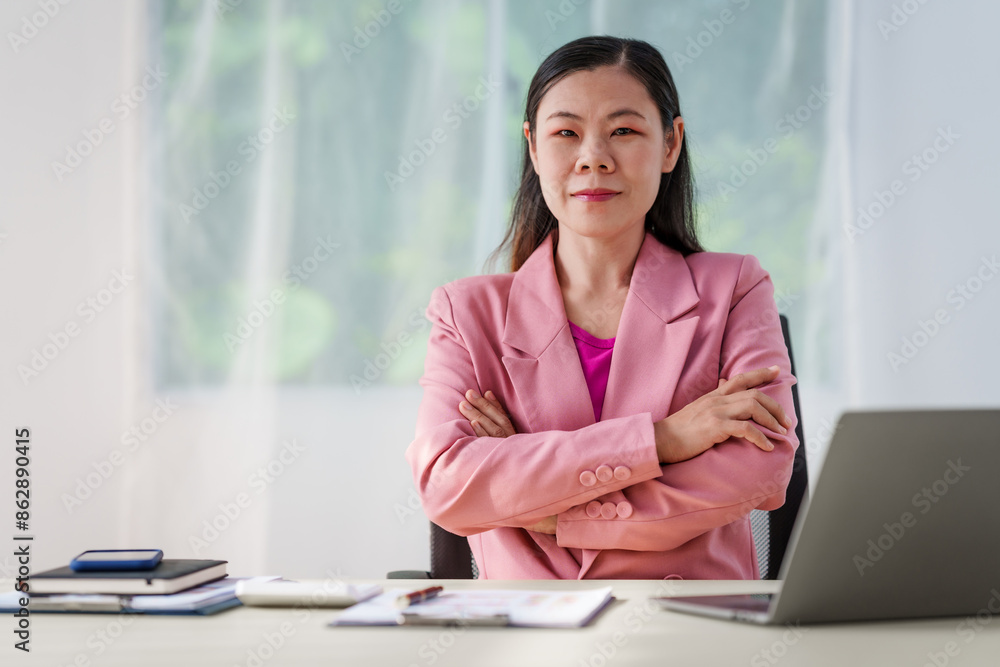 40-year-old middle-aged Asian businesswoman wearing pink suit, business finance, investment strategies, risk management. Skilled in planning, analysis, operations control for business success. 40-year-old middle-aged Asian businesswoman wearing pink suit, business finance, investment strategies, risk management. Skilled in planning, analysis, operations control for business success.