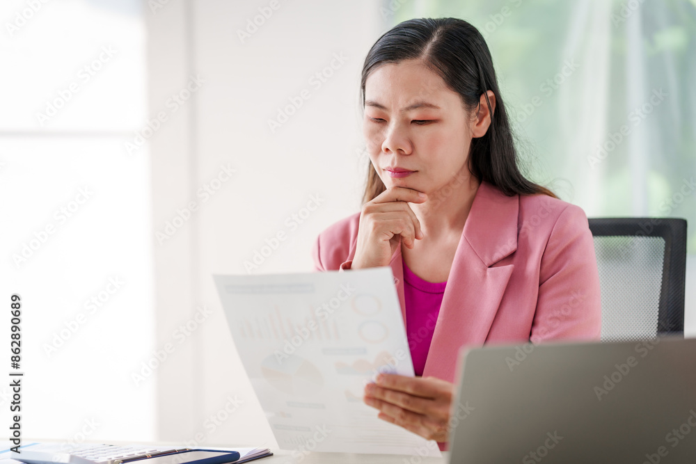 40-year-old middle-aged Asian businesswoman wearing pink suit, business finance, investment strategies, risk management. Skilled in planning, analysis, operations control for business success. 40-year-old middle-aged Asian businesswoman wearing pink suit, business finance, investment strategies, risk management. Skilled in planning, analysis, operations control for business success.