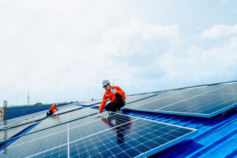 engineer man inspects construction of solar cell panel or photovoltaic cell by electronic device. Industrial Renewable energy of green power. factory worker working on tower roof. engineer man inspects construction of solar cell panel or photovoltaic cell by electronic device. Industrial Renewable energy of green power. factory worker working on tower roof.