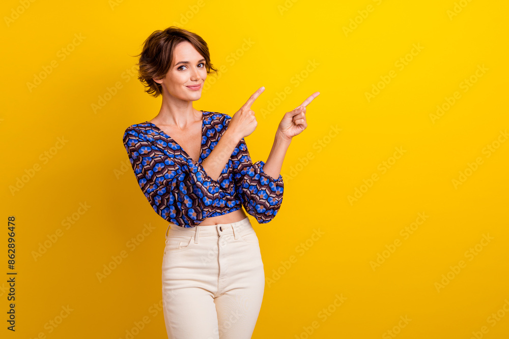 Photo of young beautiful lady brown haired model indicating forefingers copyspace temperature rate isolated on yellow color background Photo of young beautiful lady brown haired model indicating forefingers copyspace temperature rate isolated on yellow color background