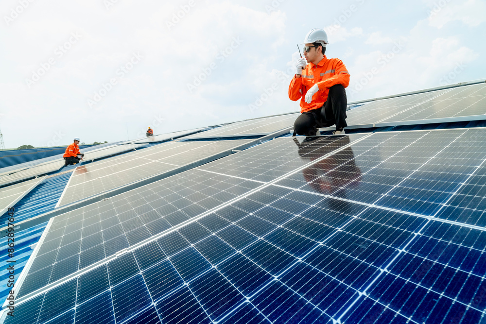 custom made wallpaper toronto digitalengineer man inspects construction of solar cell panel or photovoltaic cell by electronic device. Industrial Renewable energy of green power. factory worker working on tower roof.