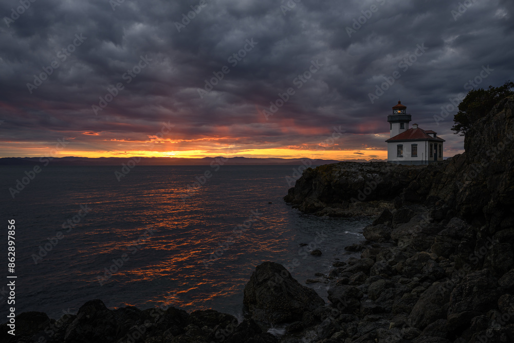 A Moody Sunset over a Lighthouse A Moody Sunset over a Lighthouse
