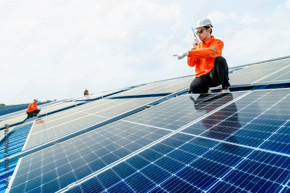 engineer man inspects construction of solar cell panel or photovoltaic cell by electronic device. Industrial Renewable energy of green power. factory worker working on tower roof. engineer man inspects construction of solar cell panel or photovoltaic cell by electronic device. Industrial Renewable energy of green power. factory worker working on tower roof.