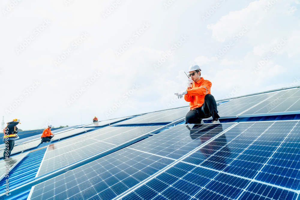 engineer man inspects construction of solar cell panel or photovoltaic cell by electronic device. Industrial Renewable energy of green power. factory worker working on tower roof. engineer man inspects construction of solar cell panel or photovoltaic cell by electronic device. Industrial Renewable energy of green power. factory worker working on tower roof.