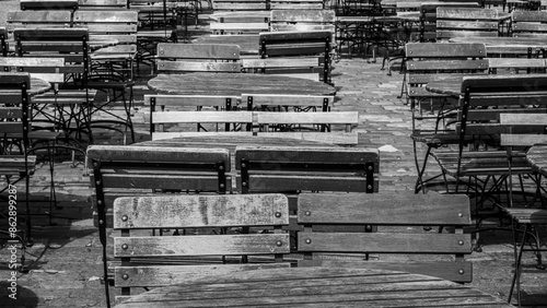 A Series of Empty Wooden Tables and Chairs Outside a Cafe in Bergen Norway