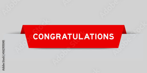 Red color inserted label with word congratulations on gray background