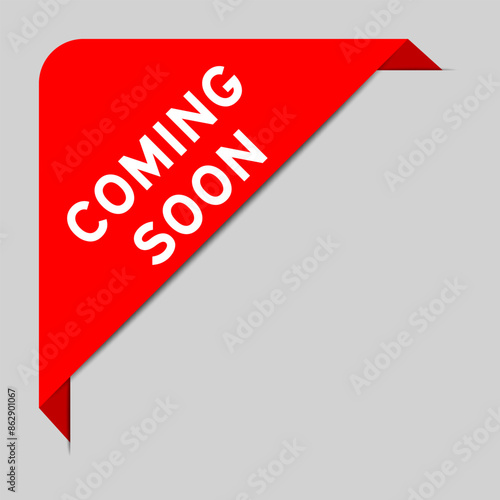 Red color of corner label banner with word coming soon on gray background