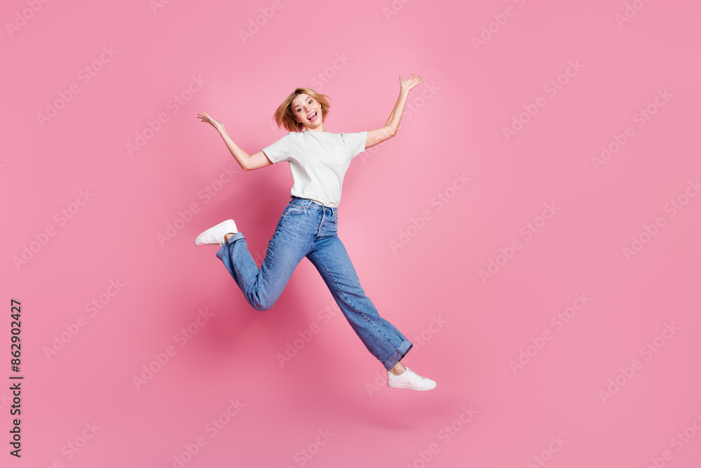 Photo of glad adorable optimistic girl wear trendy grey clothes running isolated on pink color background Photo of glad adorable optimistic girl wear trendy grey clothes running isolated on pink color background