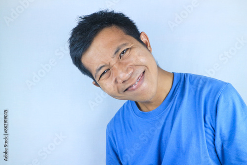 Smiling facial expression young asian man happy looking at camera, isolated on white background photo