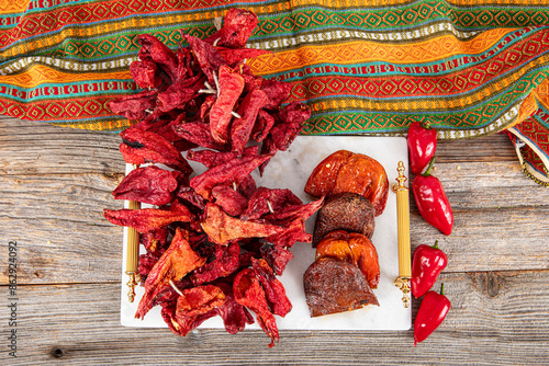 Organic dried sweet bell pepper. Dried peppers hanging in a close-up of a traditional Turkish food market. food background. Local name; Dolmalik Kuru Kapya Biber. photo