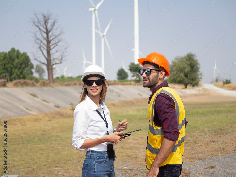 A group of engineers and architects are consulting. About taking care of wind turbines For a sustainable environment A group of engineers and architects are consulting. About taking care of wind turbines For a sustainable environment