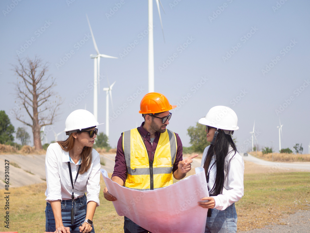 A group of engineers and architects are consulting. About taking care of wind turbines For a sustainable environment