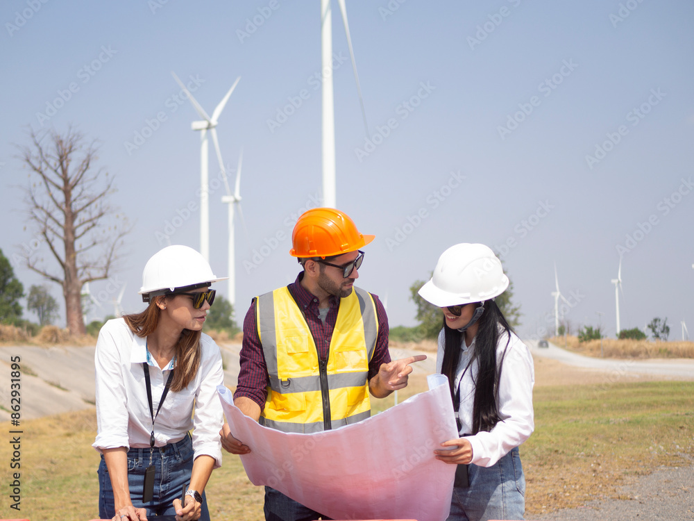 A group of engineers and architects are consulting. About taking care of wind turbines For a sustainable environment A group of engineers and architects are consulting. About taking care of wind turbines For a sustainable environment