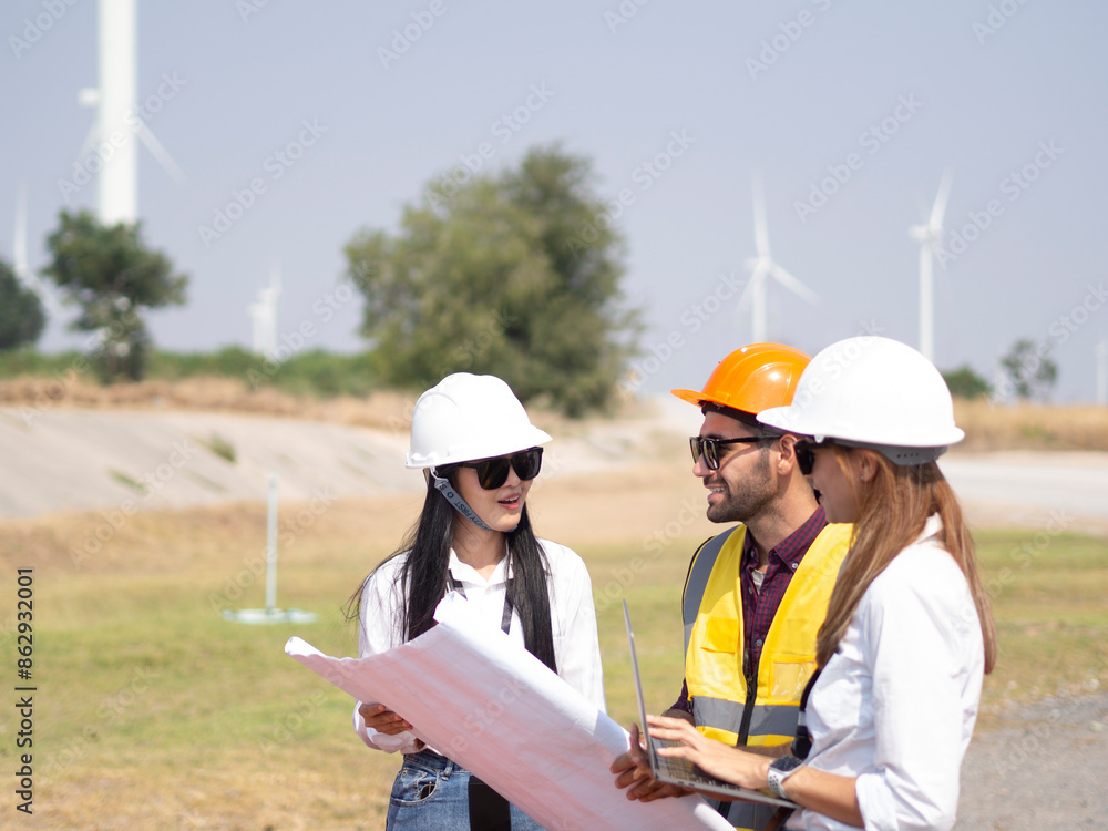 A group of engineers and architects are consulting. About taking care of wind turbines For a sustainable environment A group of engineers and architects are consulting. About taking care of wind turbines For a sustainable environment