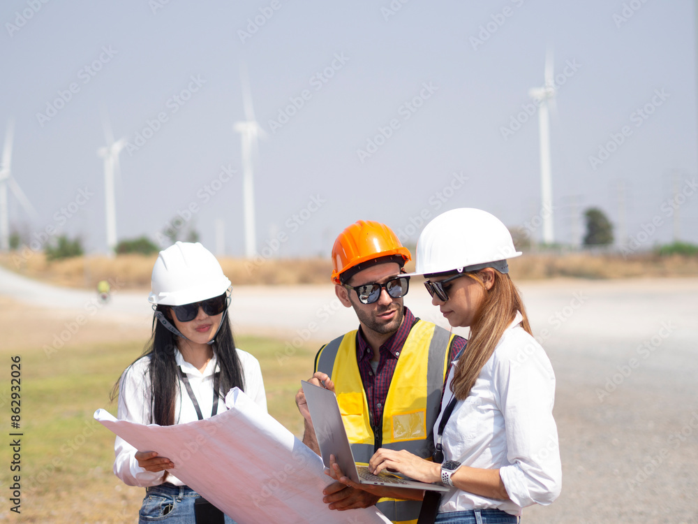 A group of engineers and architects are consulting. About taking care of wind turbines For a sustainable environment