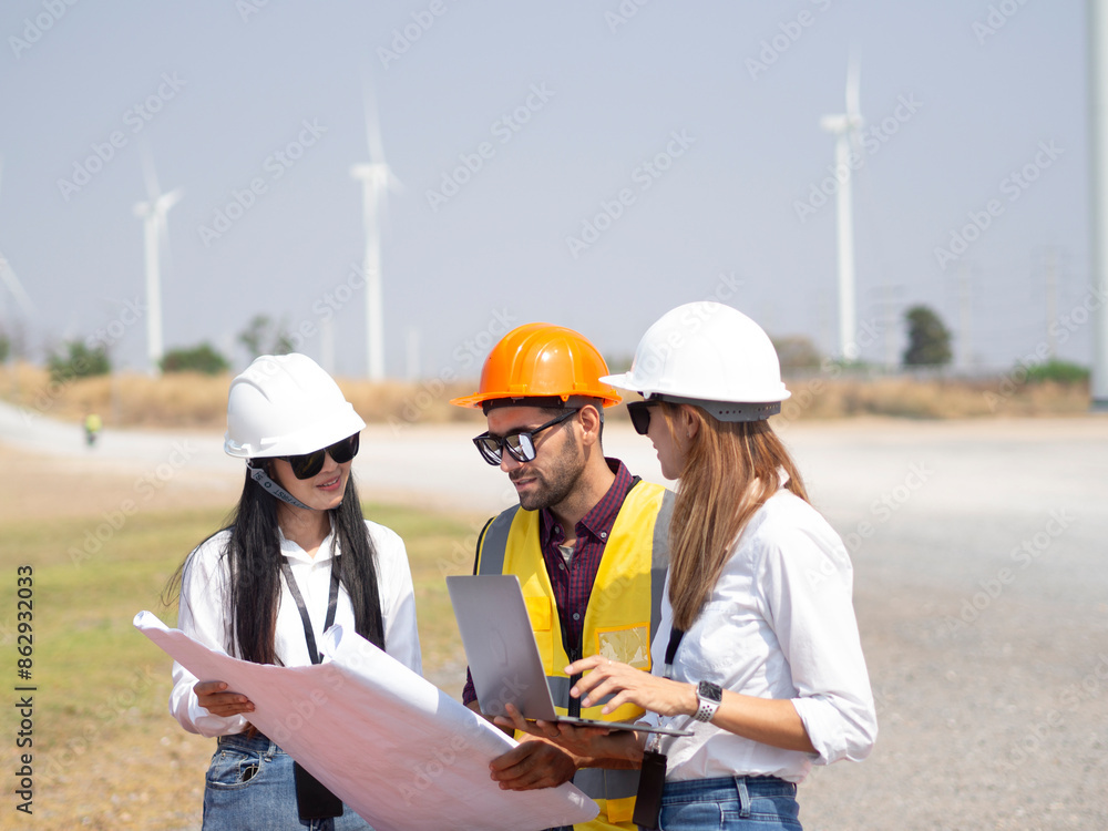 A group of engineers and architects are consulting. About taking care of wind turbines For a sustainable environment