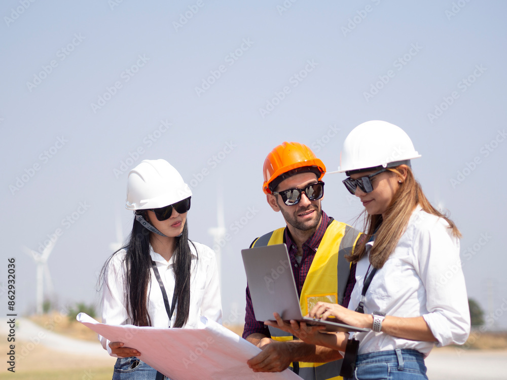A group of engineers and architects are consulting. About taking care of wind turbines For a sustainable environment A group of engineers and architects are consulting. About taking care of wind turbines For a sustainable environment