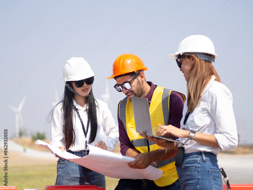 A group of engineers and architects are consulting. About taking care of wind turbines For a sustainable environment A group of engineers and architects are consulting. About taking care of wind turbines For a sustainable environment