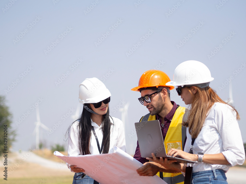 A group of engineers and architects are consulting. About taking care of wind turbines For a sustainable environment A group of engineers and architects are consulting. About taking care of wind turbines For a sustainable environment