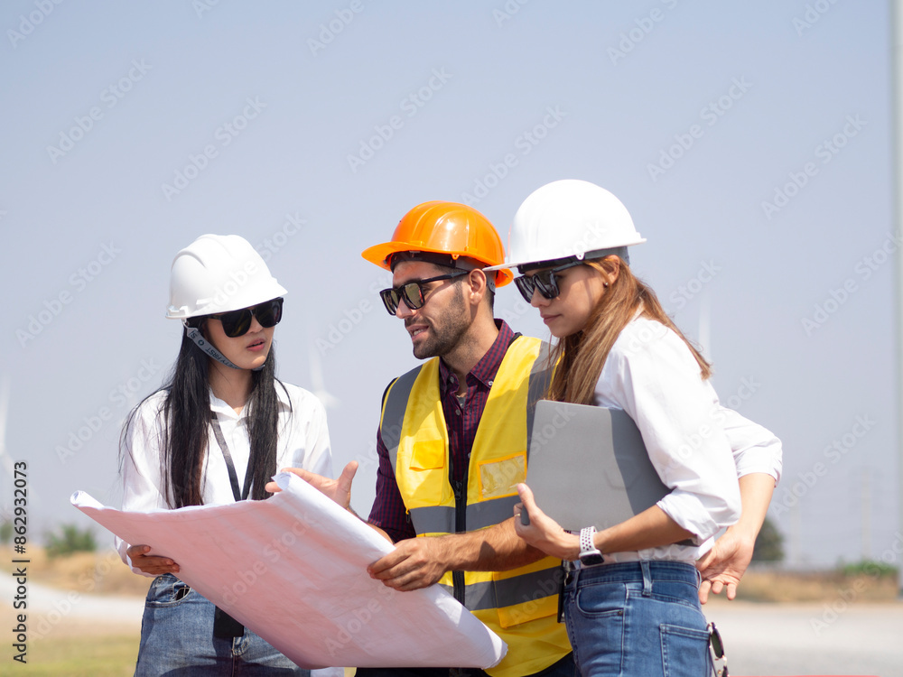 A group of engineers and architects are consulting. About taking care of wind turbines For a sustainable environment A group of engineers and architects are consulting. About taking care of wind turbines For a sustainable environment