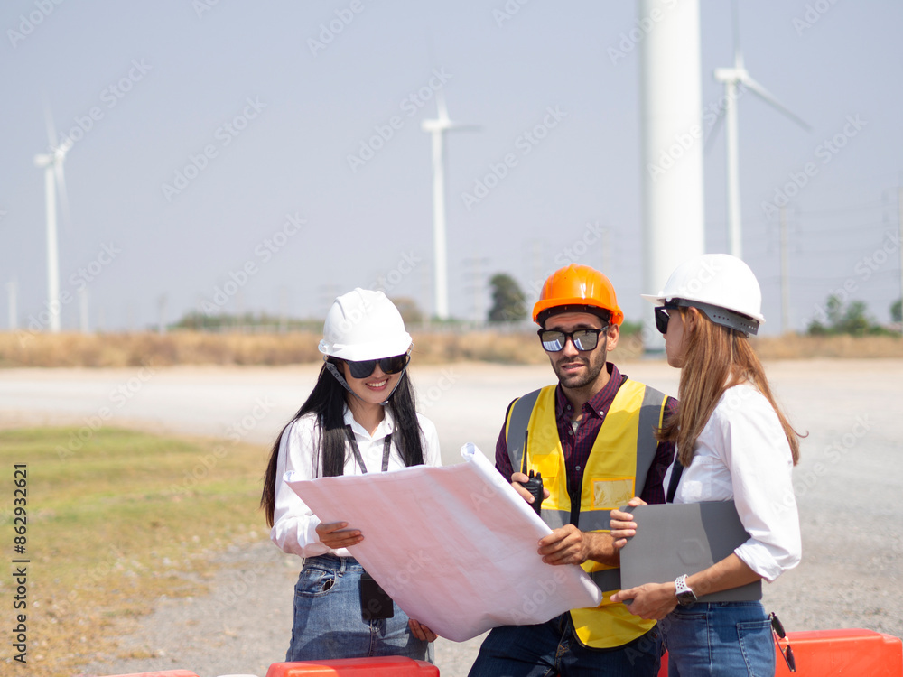A group of engineers and architects are consulting. About taking care of wind turbines For a sustainable environment A group of engineers and architects are consulting. About taking care of wind turbines For a sustainable environment