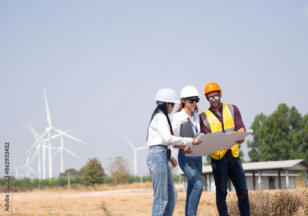 A group of engineers and architects are consulting. About taking care of wind turbines For a sustainable environment A group of engineers and architects are consulting. About taking care of wind turbines For a sustainable environment