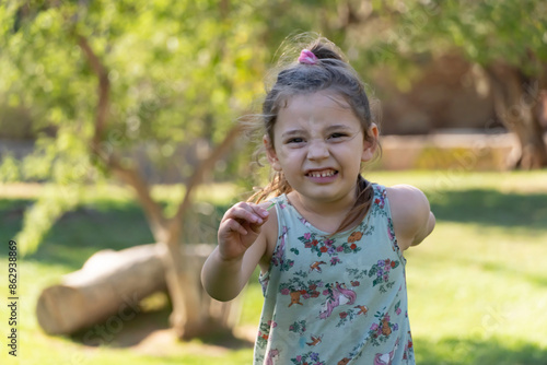 Naughty Face: Girl Running and Making Gestures on a Sunny Day