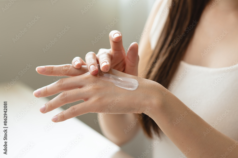 Health skin care, beauty smile asian young woman, girl hand applying, putting moisturizer on her arm, shoulder after shower bath at home. Skin body cream moisturizing lotion, routine in the morning. Health skin care, beauty smile asian young woman, girl hand applying, putting moisturizer on her arm, shoulder after shower bath at home. Skin body cream moisturizing lotion, routine in the morning.