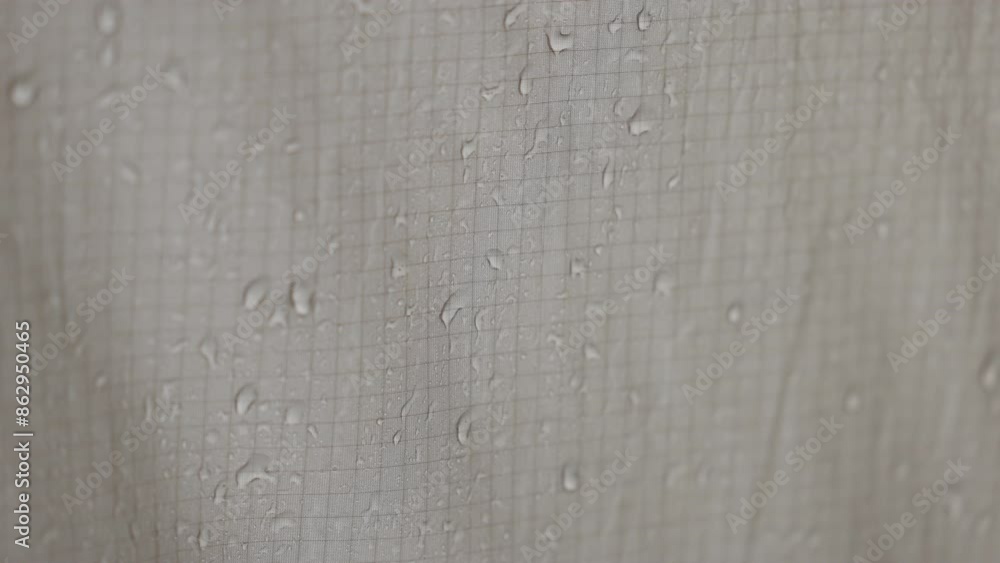 Raindrops on tent. Tourist equipment in wildlife in wet season. Close-up shot of raindrops water droplets on the tent. Camp, hiking tourism, waterproof home. Rain is pounding on tent slow motion video Raindrops on tent. Tourist equipment in wildlife in wet season. Close-up shot of raindrops water droplets on the tent. Camp, hiking tourism, waterproof home. Rain is pounding on tent slow motion video