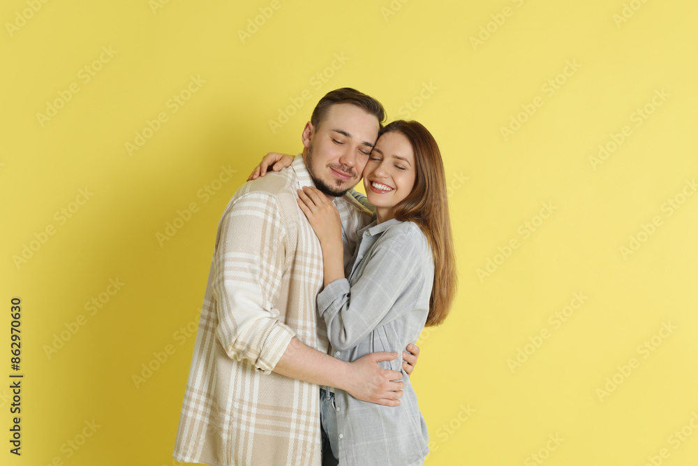 Happy couple hugging on yellow background. Strong relationship Happy couple hugging on yellow background. Strong relationship