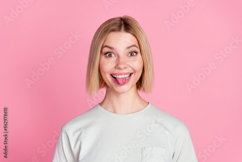 Portrait of nice young lady show tongue wear t-shirt isolated on pink color background