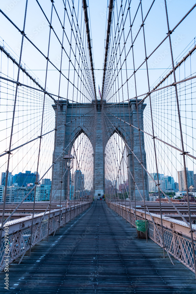 Naklejka premium new york city architecture. brooklyn bridge to manhattan. urban architecture landmark of brooklyn bridge. architecture of metropolis city. brooklyn bridge. Architectural marvel