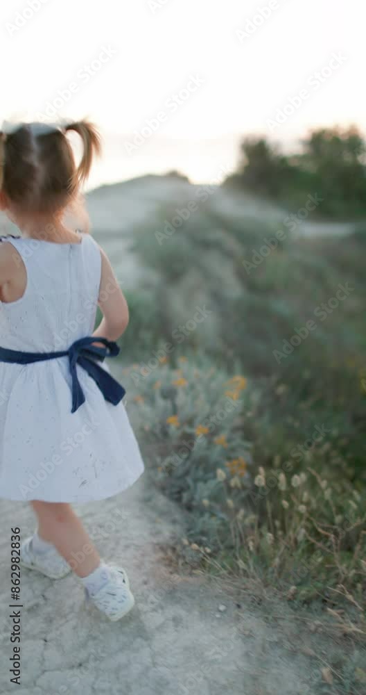 Cute caucasian child girl outdoor walking with mother Cute caucasian child girl outdoor walking with mother