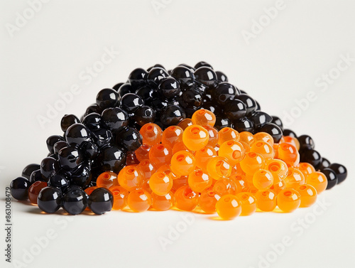 A pile of caviar with some orange and black ones photo