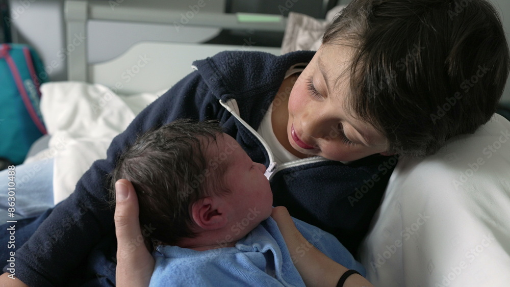 Young boy meeting his newborn baby at hospital in tender heartwarming moment between brothers at hospital, first day of life of an infant being welcomed by sibling, eskimo kiss Young boy meeting his newborn baby at hospital in tender heartwarming moment between brothers at hospital, first day of life of an infant being welcomed by sibling, eskimo kiss