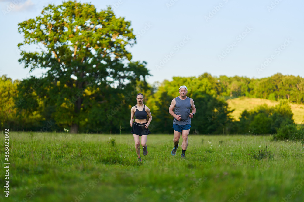 Fitness couple jogging in the forest Fitness couple jogging in the forest