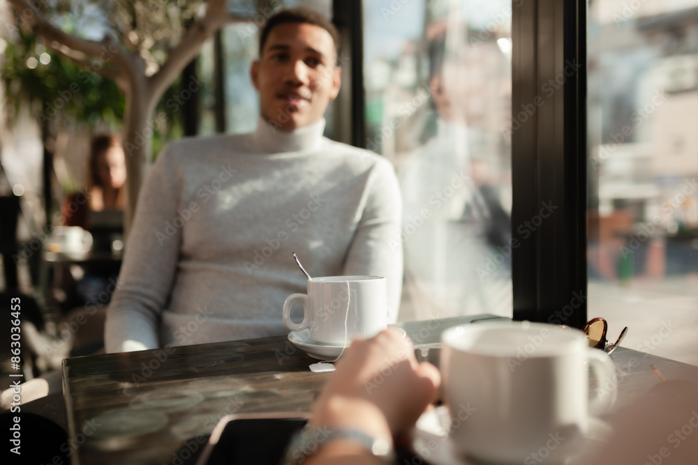 Friends in a restaurant talking smiling and drinking tea. Business colleagues having a meeting after work or during coffee break at a cafe bar.. Friends in a restaurant talking smiling and drinking tea. Business colleagues having a meeting after work or during coffee break at a cafe bar..
