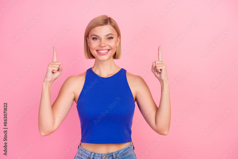 Portrait of nice young girl direct fingers up empty space wear blue top isolated on pink color background Portrait of nice young girl direct fingers up empty space wear blue top isolated on pink color background