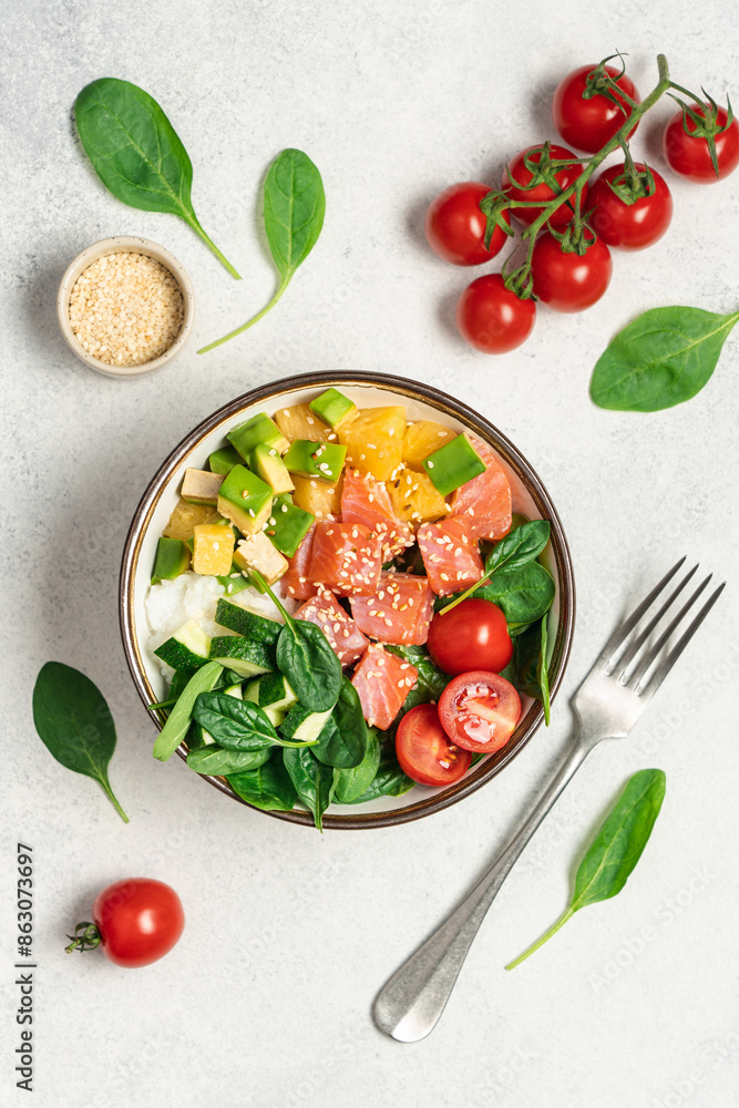 Salmon bowl with spinach, rice, avocado, tomato, cucumbers on a white background, top view. Poke bowl, healthy eating Salmon bowl with spinach, rice, avocado, tomato, cucumbers on a white background, top view. Poke bowl, healthy eating