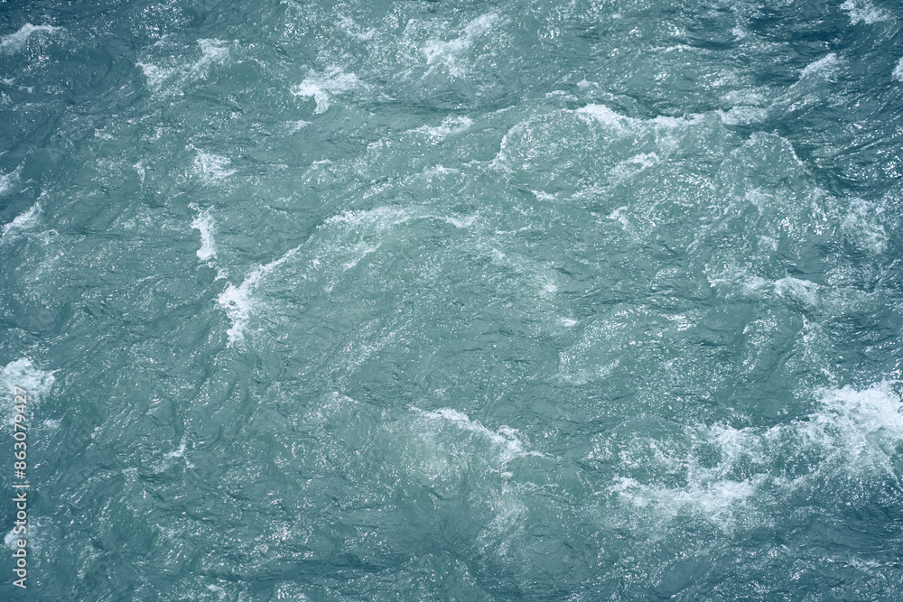 Ripples and waves on the water. Beautiful background with blue water and a place to copy. Close-up of raging water. High quality photo Ripples and waves on the water. Beautiful background with blue water and a place to copy. Close-up of raging water. High quality photo