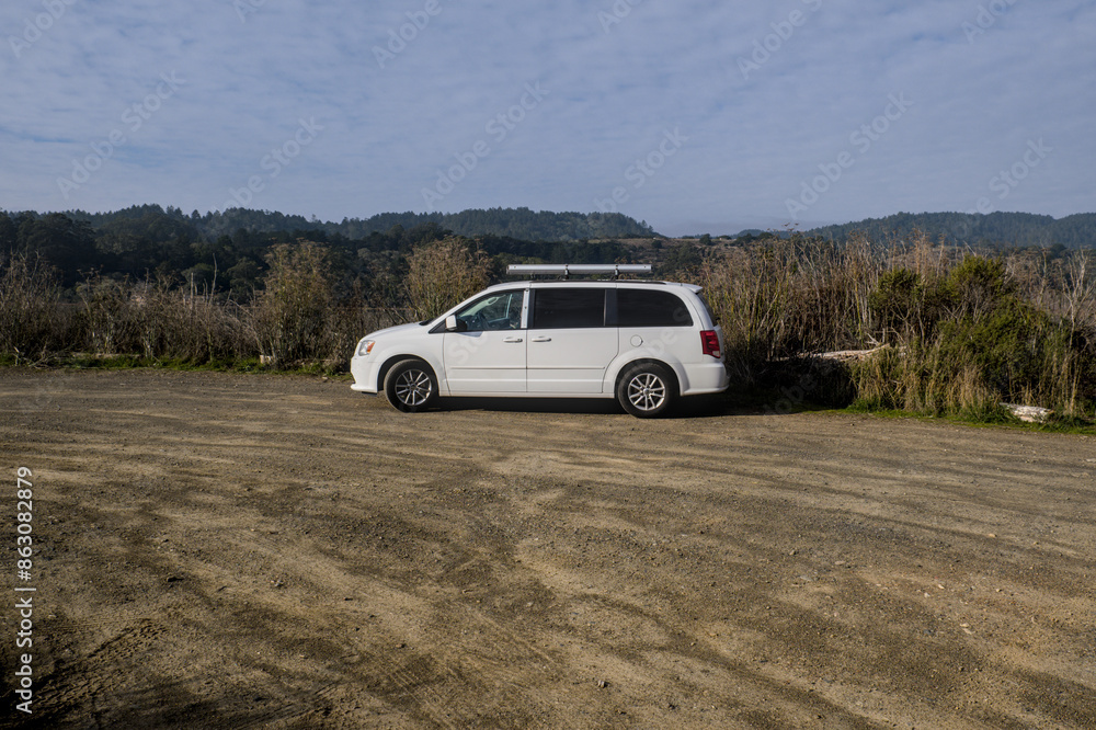Minivan car parked on a terrain land Minivan car parked on a terrain land